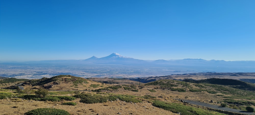 a view of a mountain range with a road running through it