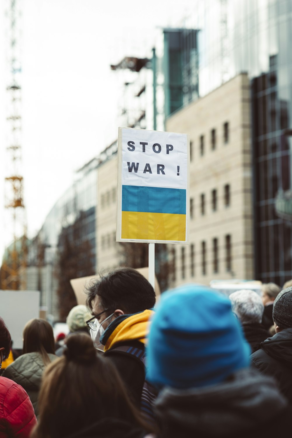 a group of people holding a sign that says stop war