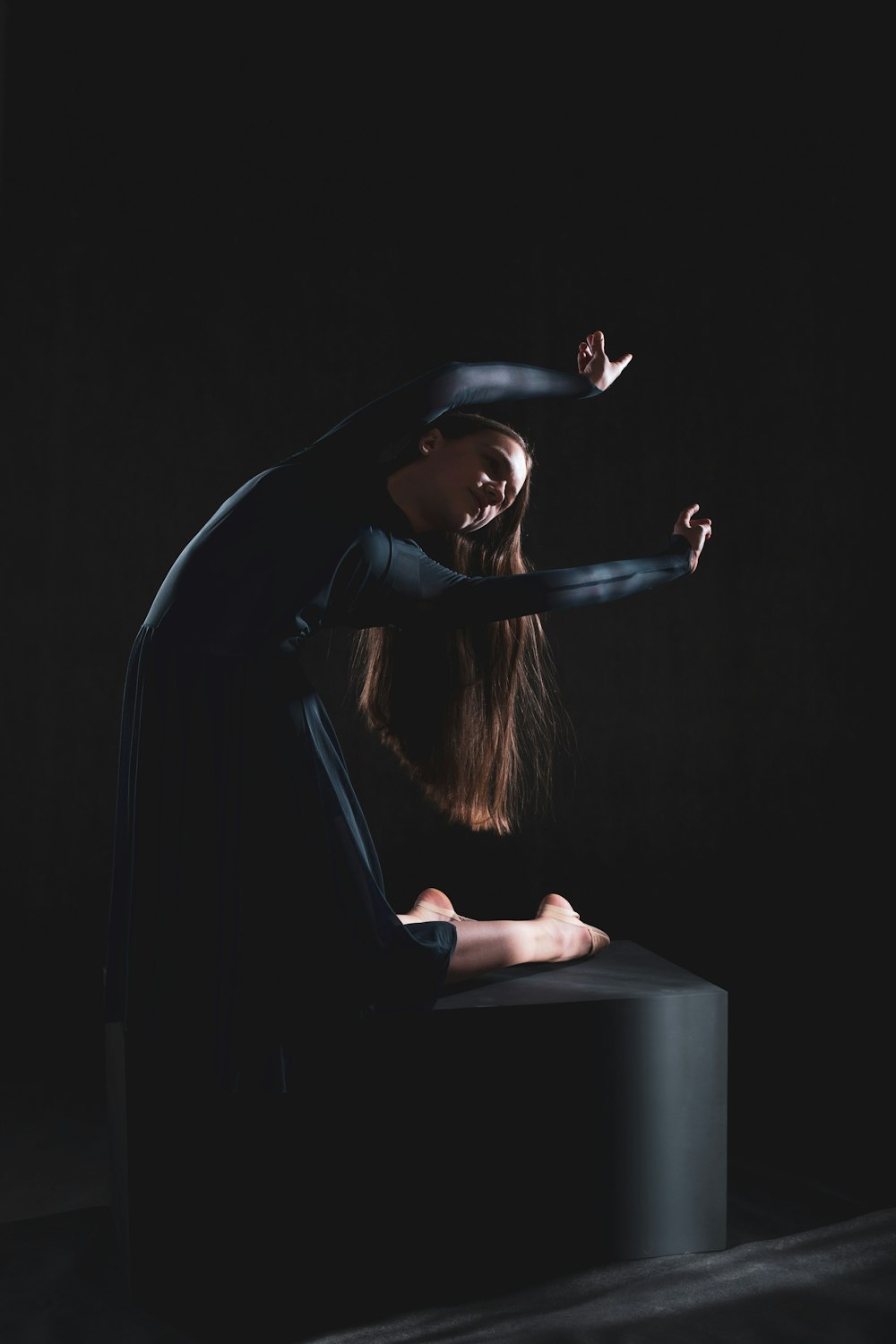 a woman is doing a handstand on a stool