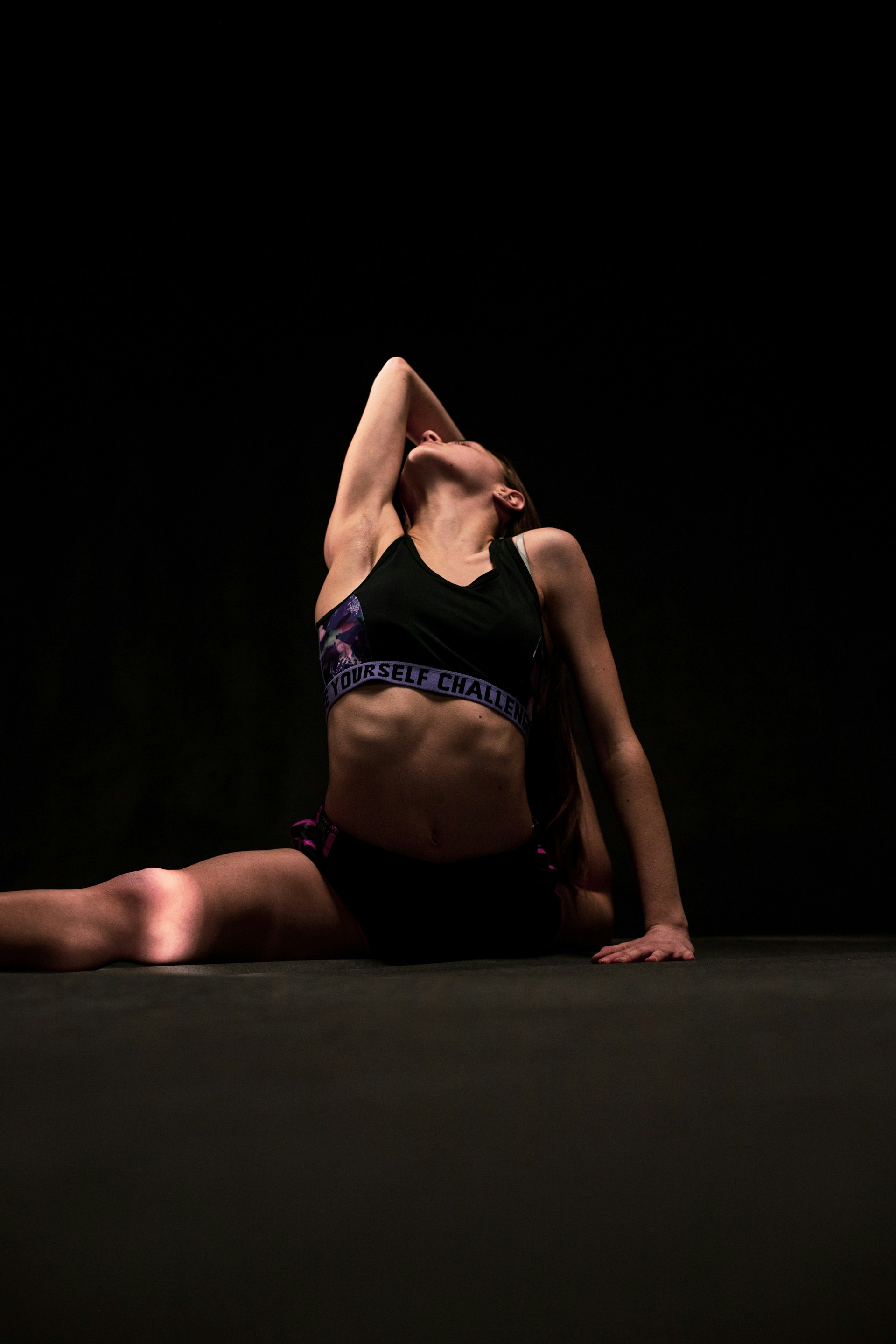 a woman in a black sports bra top doing a handstand