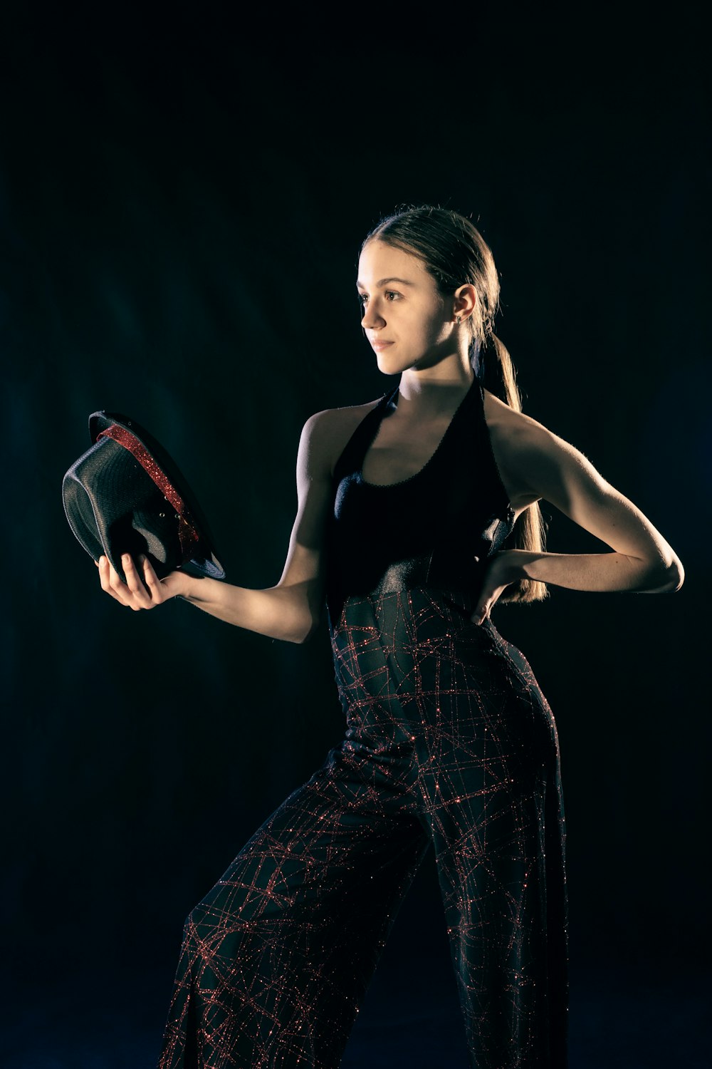 a woman is holding a tennis racket and posing for a picture