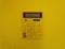 a calculator mounted on a yellow wall