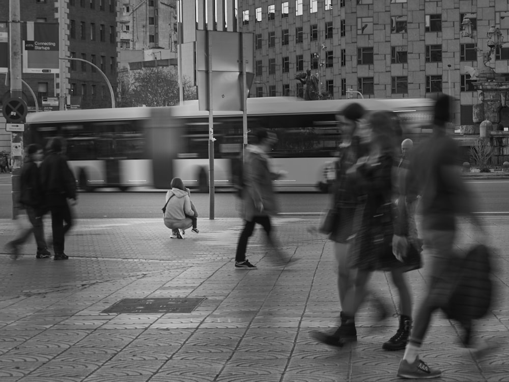 a group of people walking across a street