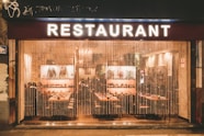 a restaurant that is lit up at night