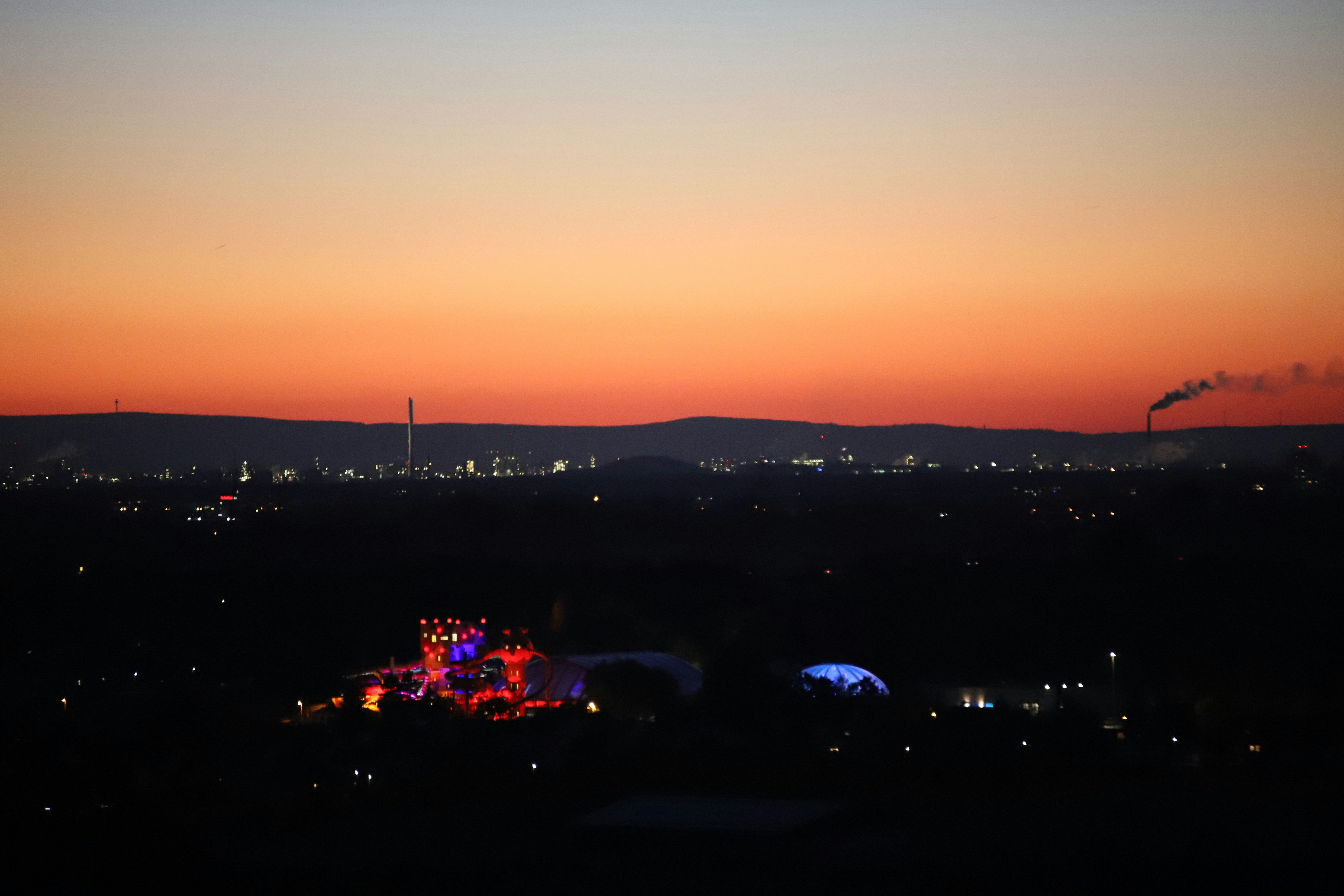a view of a city at night from a hill