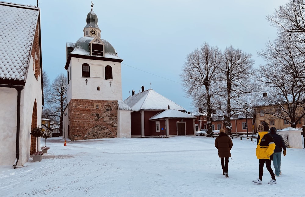 a group of people walking down a snow covered street