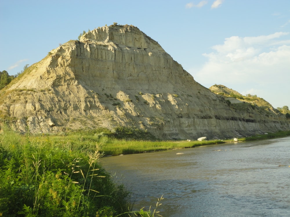 a large rock formation next to a body of water