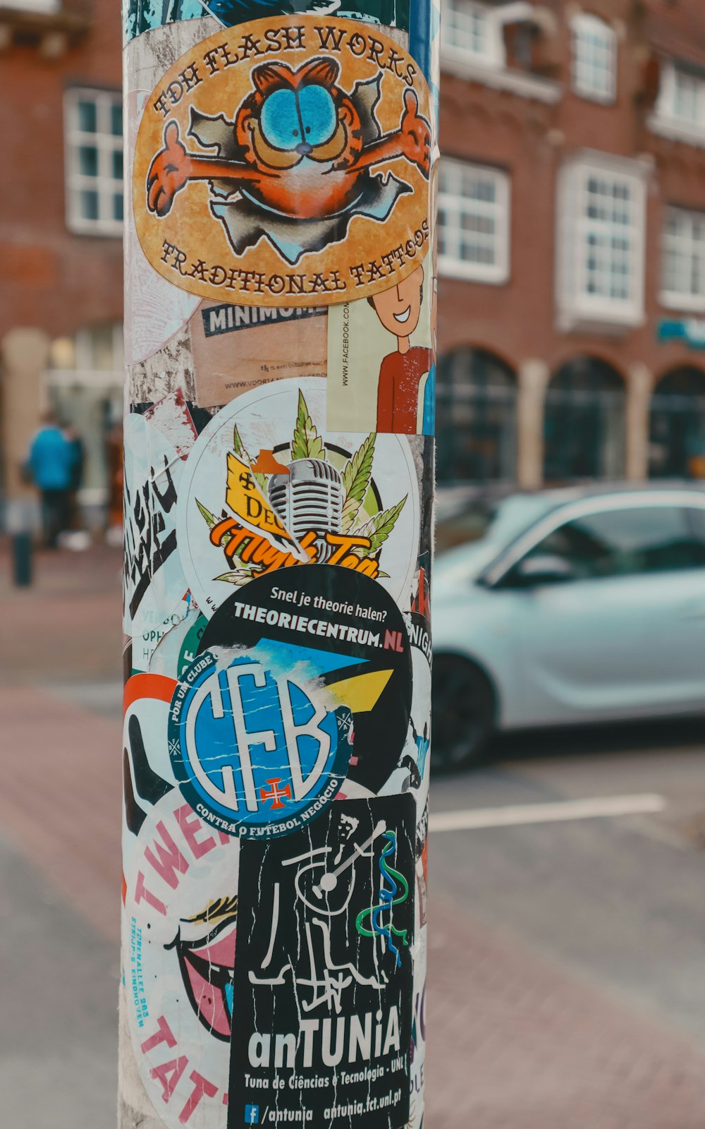 a pole with a bunch of stickers on it