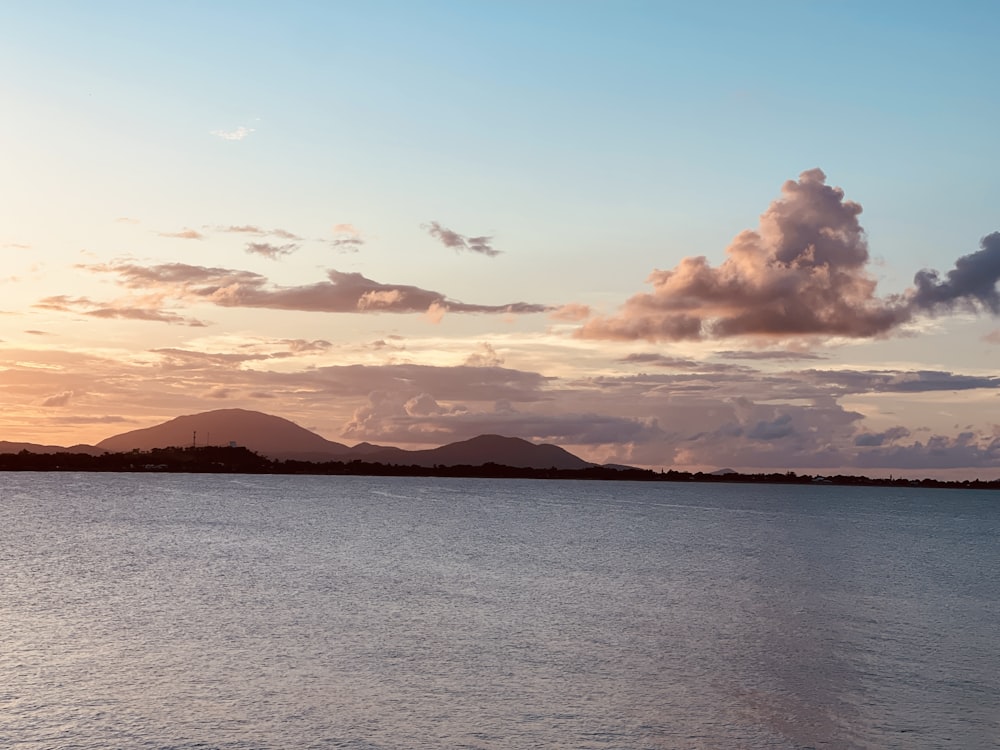 a large body of water sitting under a cloudy sky