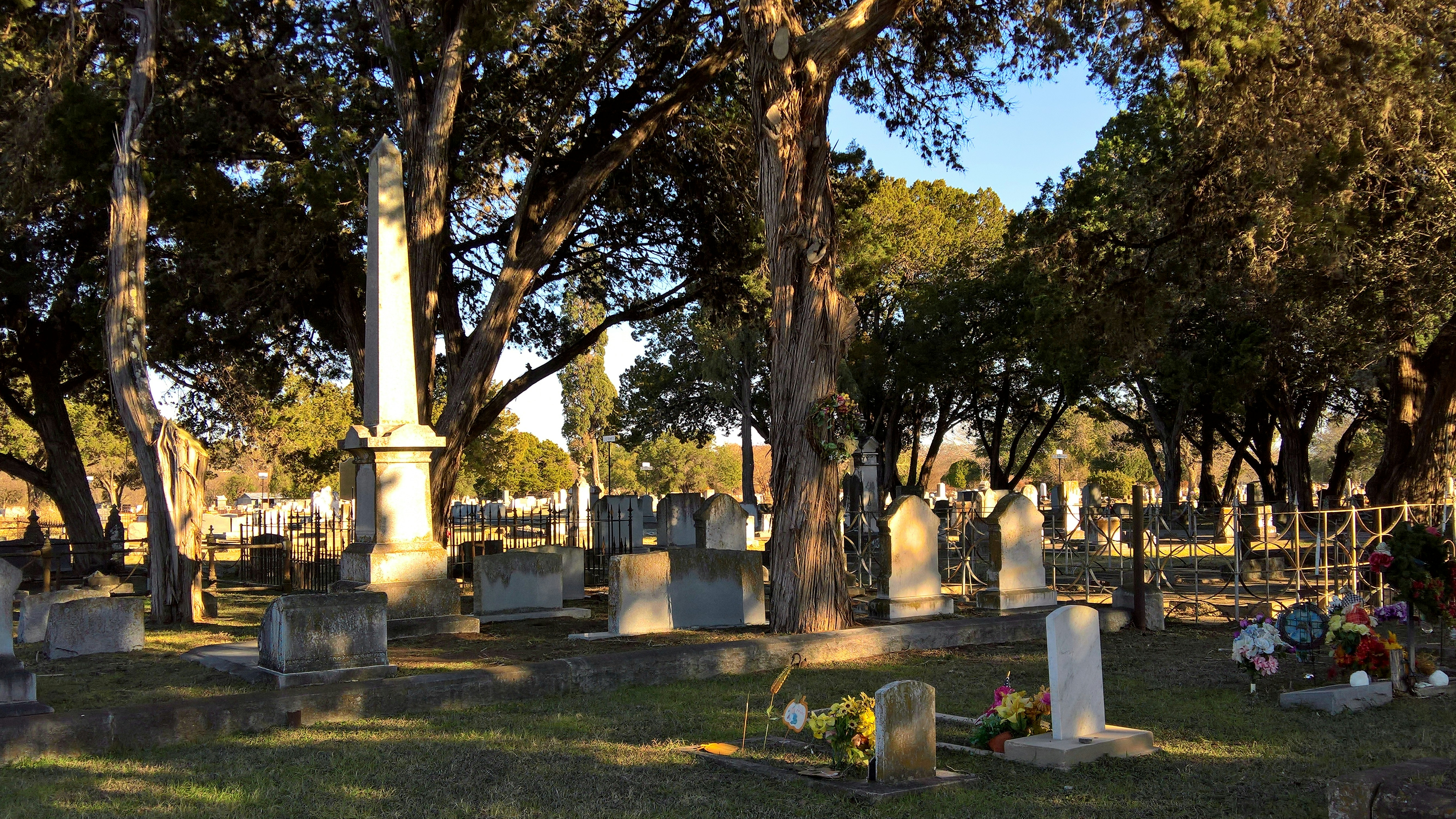 a cemetery with many headstones and trees