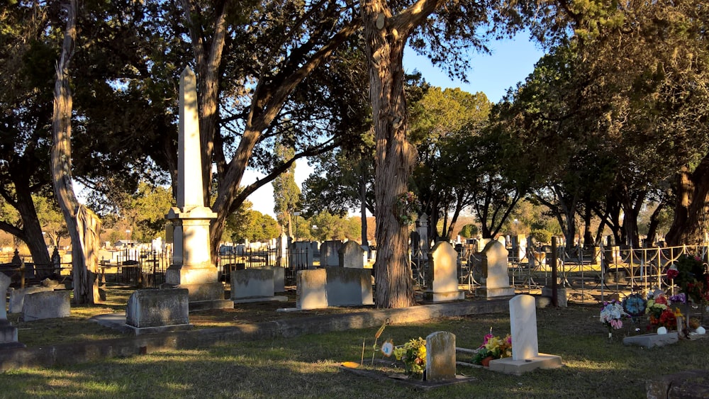 a cemetery with many headstones and trees