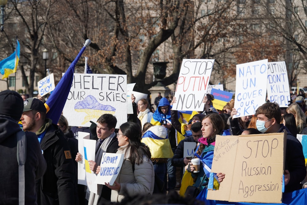 a large group of people holding signs and flags