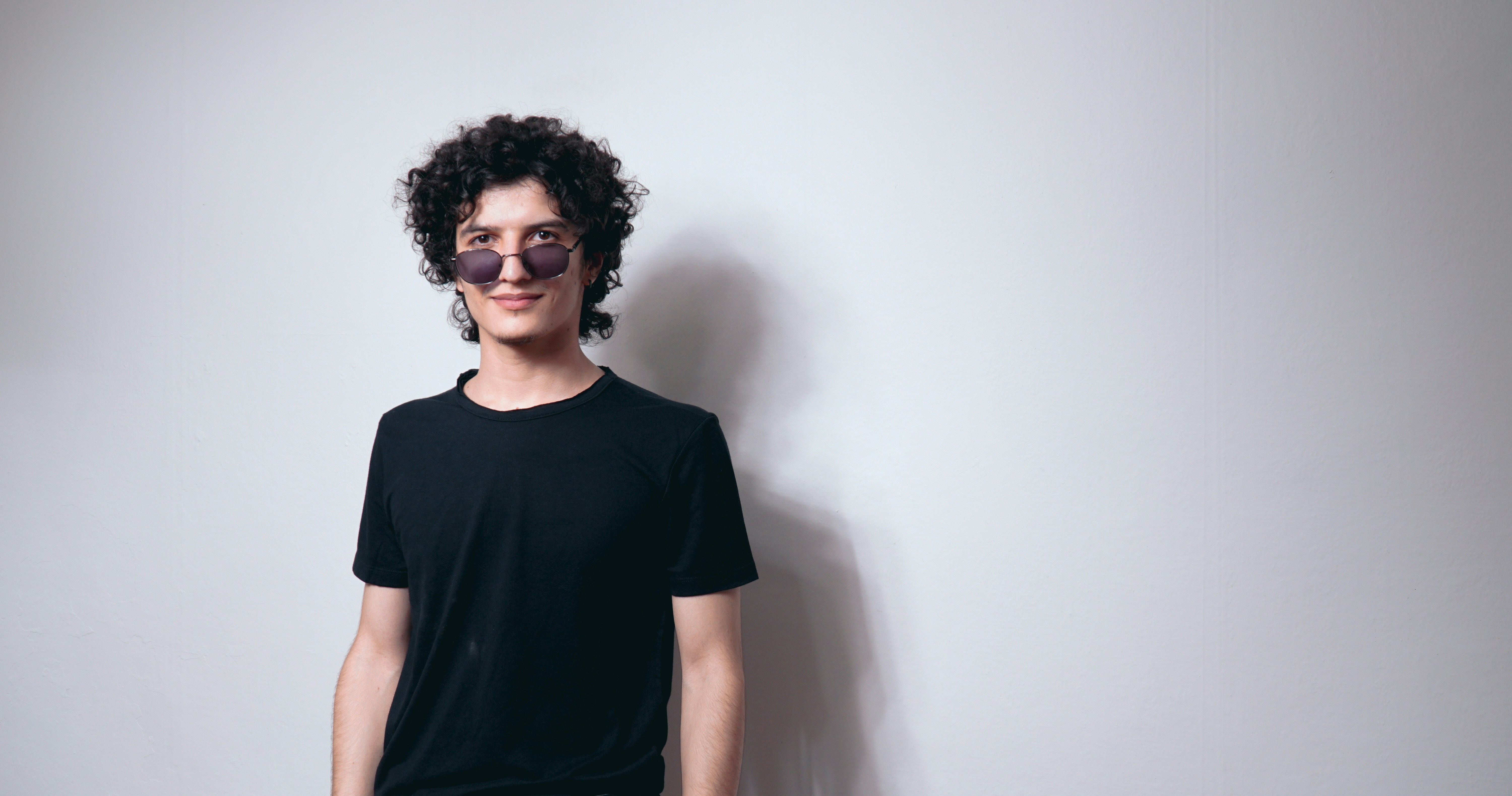 Marcus Rivera, young man with curly hair