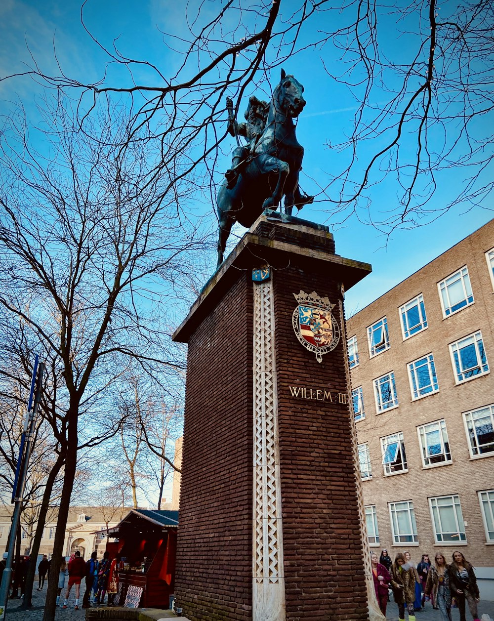 a statue of a man on a horse on top of a building