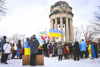 Volunteers distributing emergency supplies to Ukrainian families in Edmonton on a bright day.