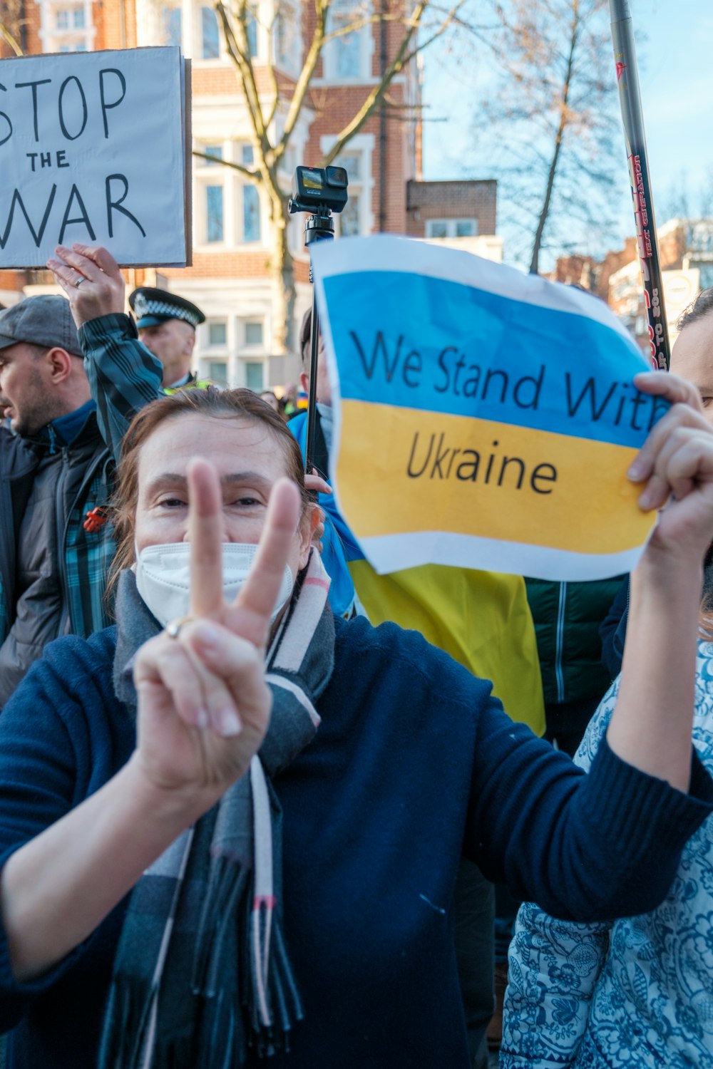 a group of people standing around each other holding up signs