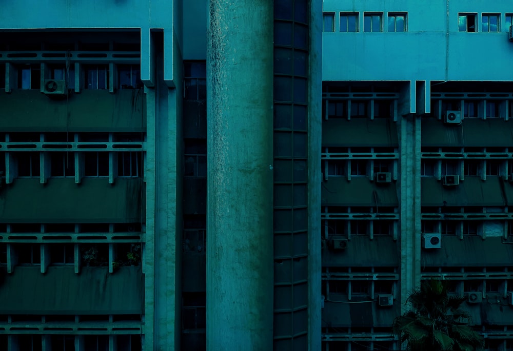 a tall building with lots of windows next to a street sign