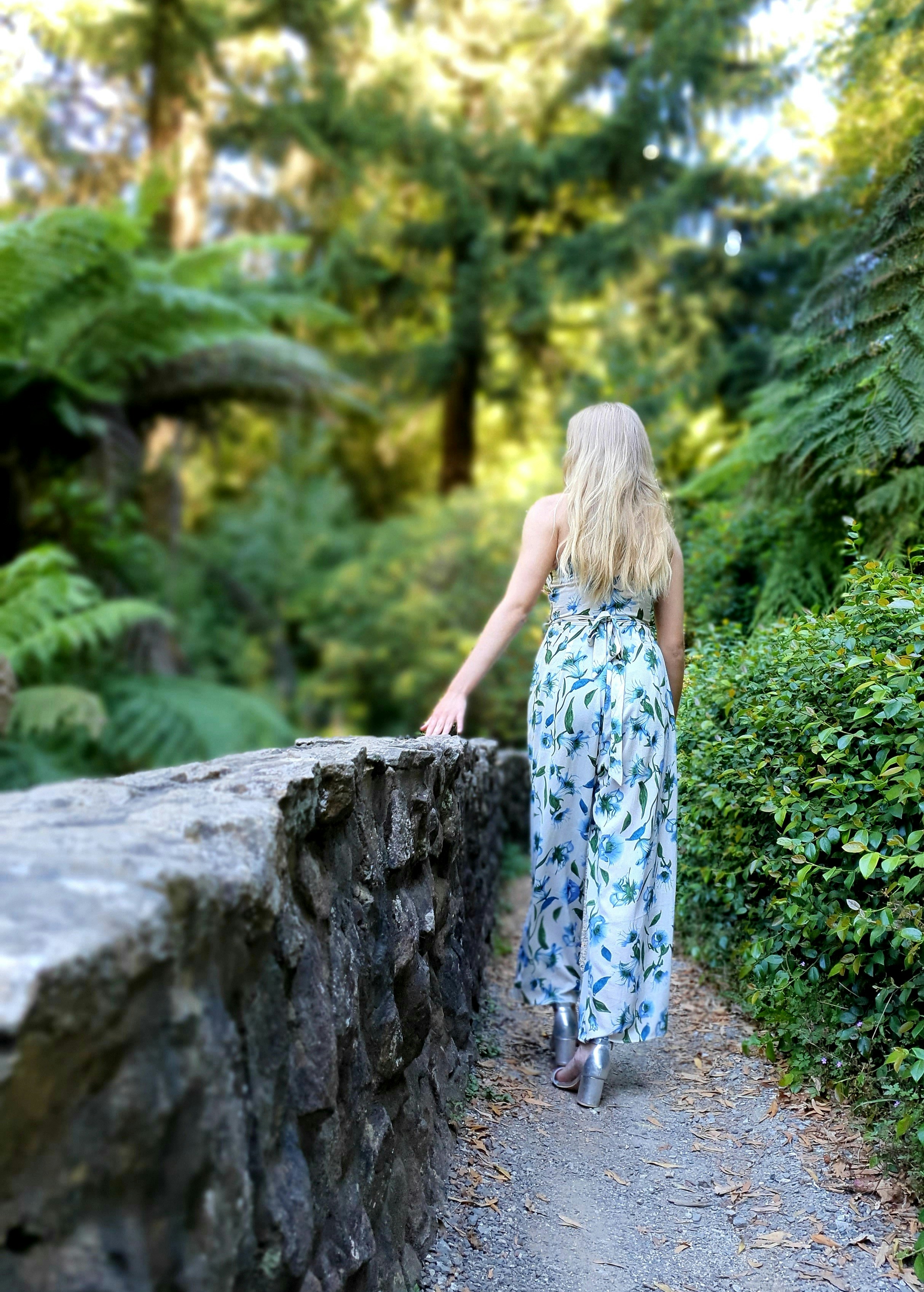 A woman in a dress walking on a path photo – Free Forest Image on Unsplash