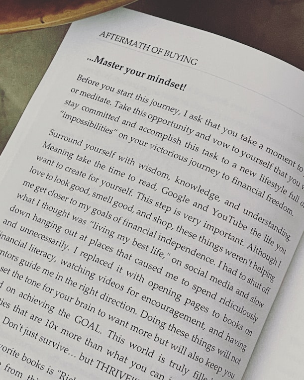 A page from a book titled 'Aftermath of Buying' focuses on mastering one's mindset. The text advises taking time to meditate, surround yourself with wisdom and understanding, and avoid distractions. It emphasizes setting goals and thriving instead of just surviving.