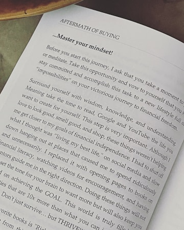A page from a book titled 'Aftermath of Buying' focuses on mastering one's mindset. The text advises taking time to meditate, surround yourself with wisdom and understanding, and avoid distractions. It emphasizes setting goals and thriving instead of just surviving.