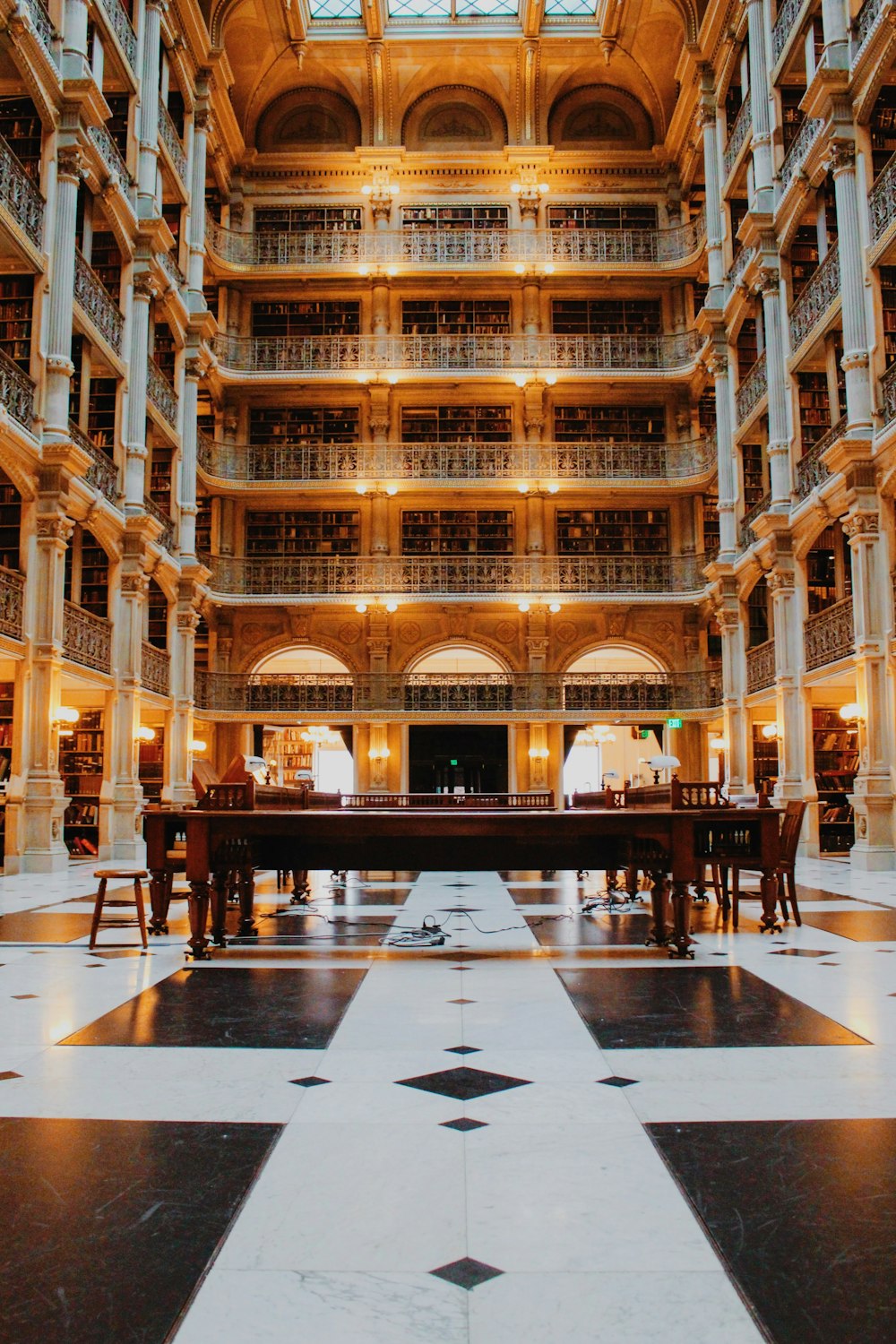 the inside of a large building with tables and chairs