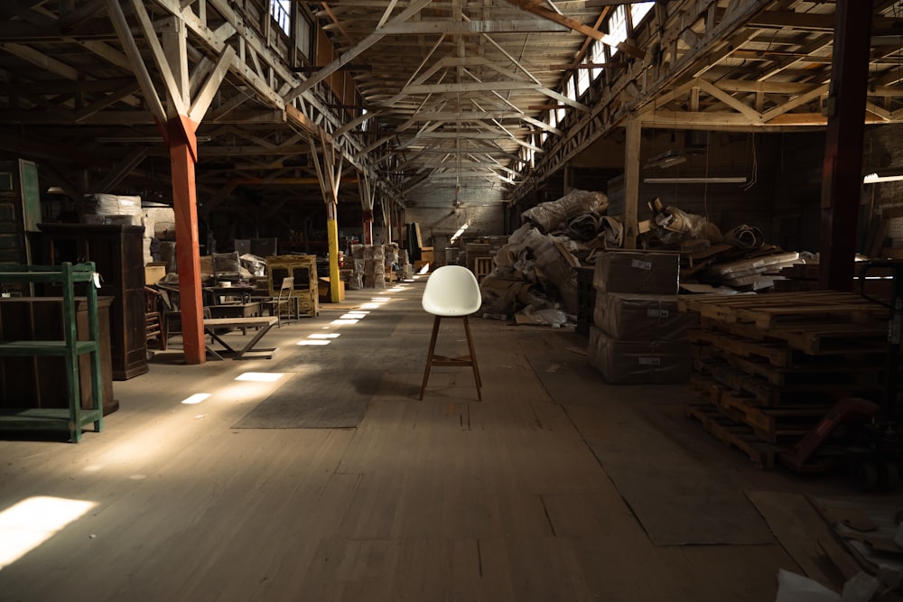 a large warehouse with a lamp on the floor