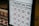 A pricing board for various types of massages, including Thai massage, foot massage, oil massage, and back-head-shoulder massage. Prices are listed for different time durations ranging from half an hour to two hours.