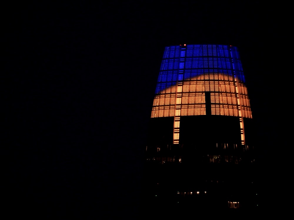 a very tall building lit up in the dark