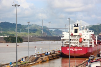 a large red and white boat docked at a dock