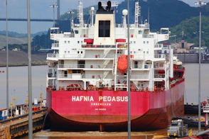 a large red and white boat docked at a dock