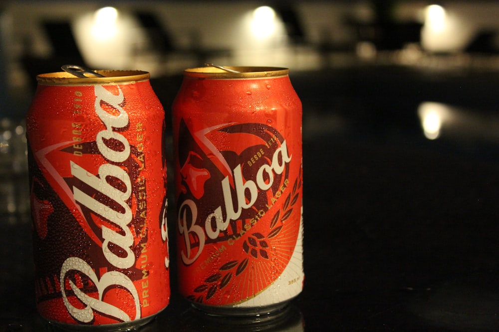 two cans of budweiser are sitting on a table