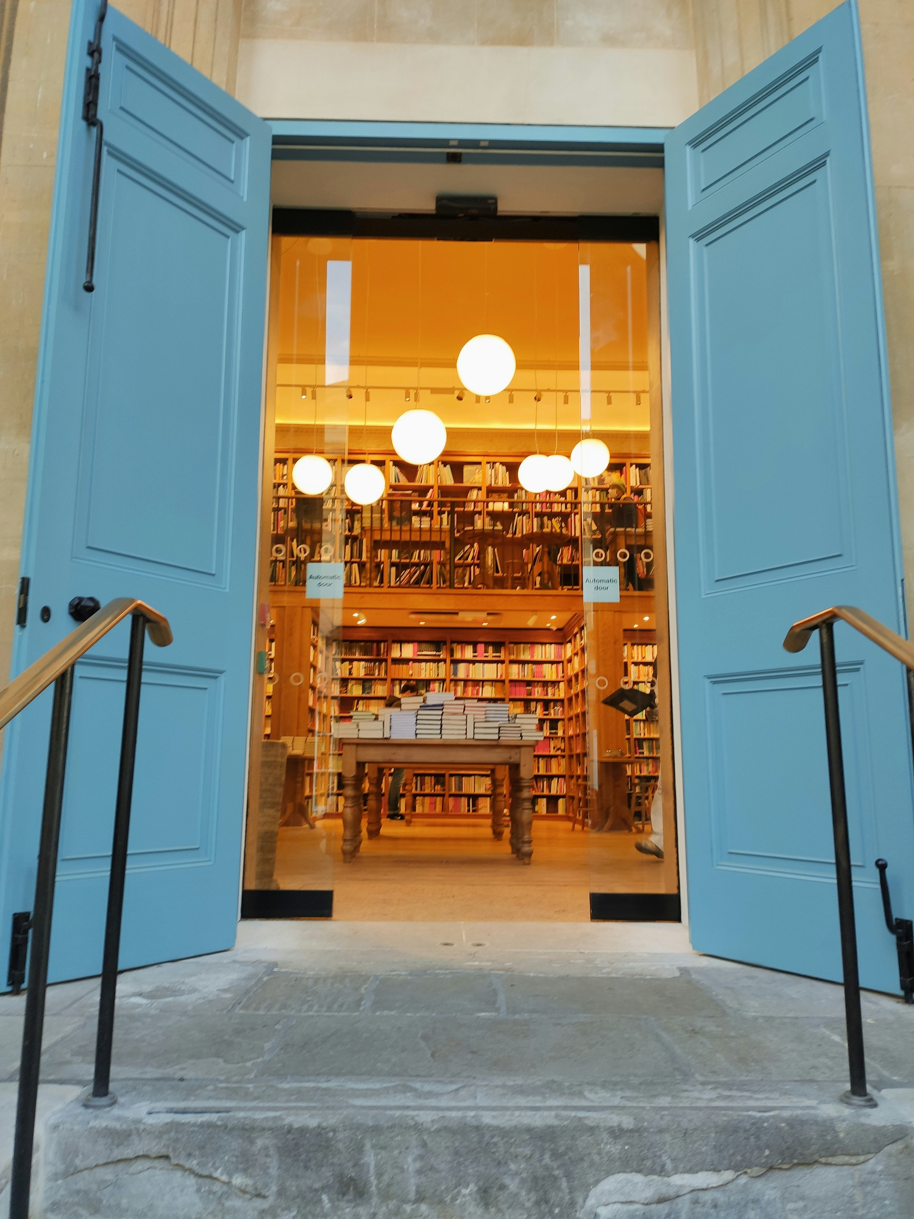 An open door leading to a library filled with books photo – Free ...