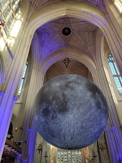 A serene moonlit chapel interior with golden accents and deep blue shadows.