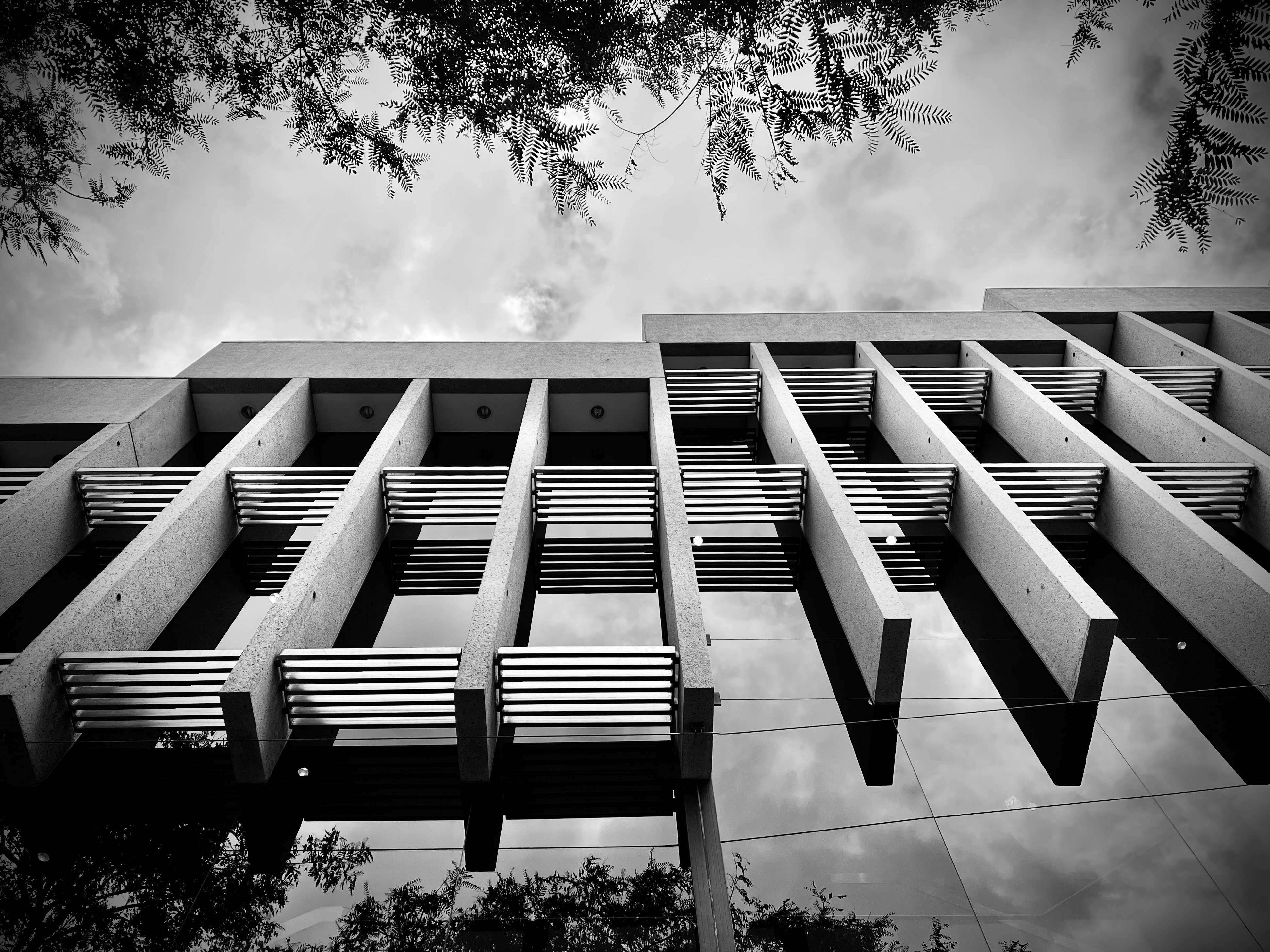 a black and white photo of a building with benches