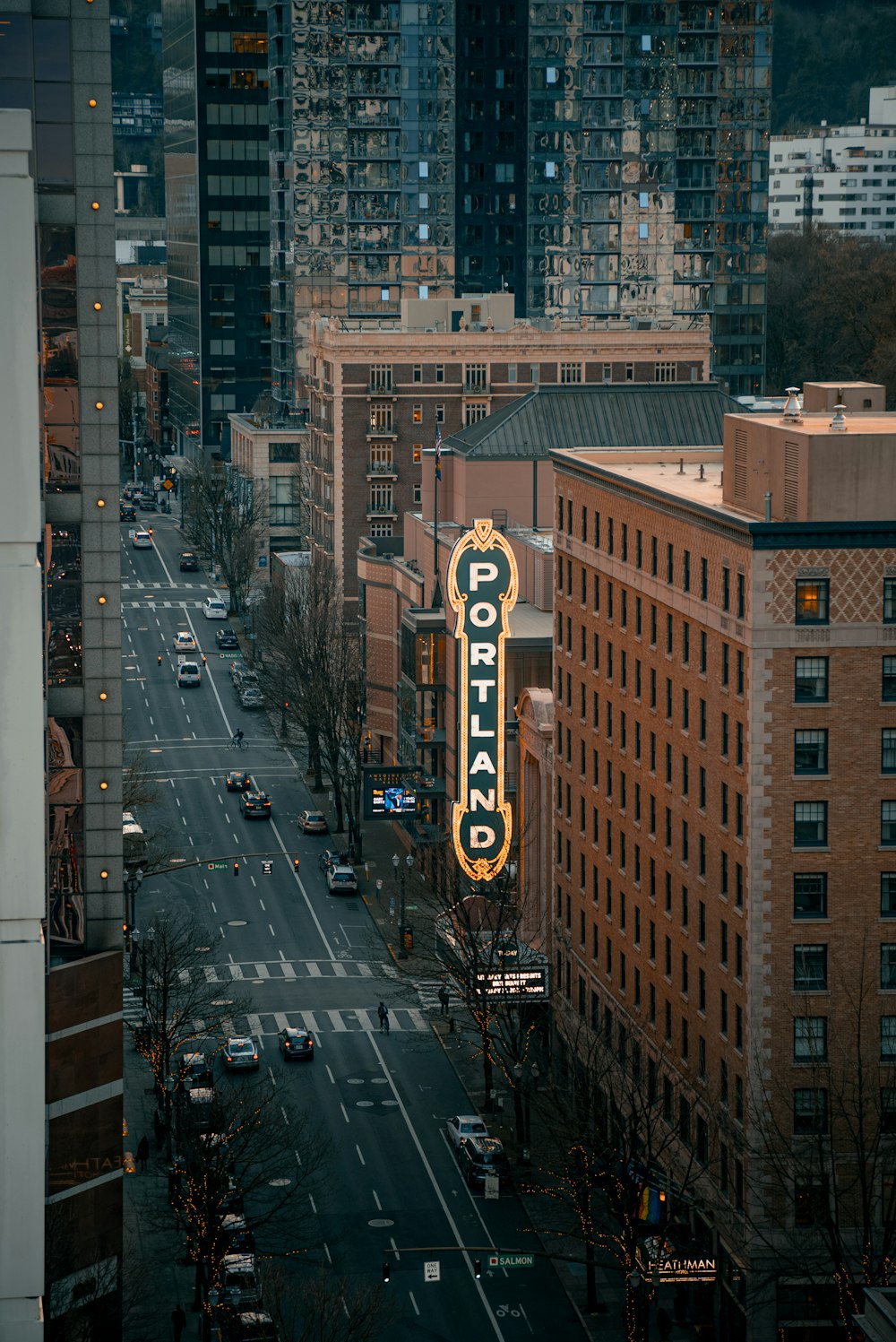 a city street filled with traffic and tall buildings