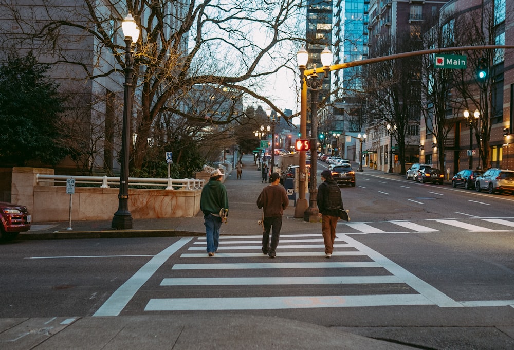 a couple of people that are walking across a street