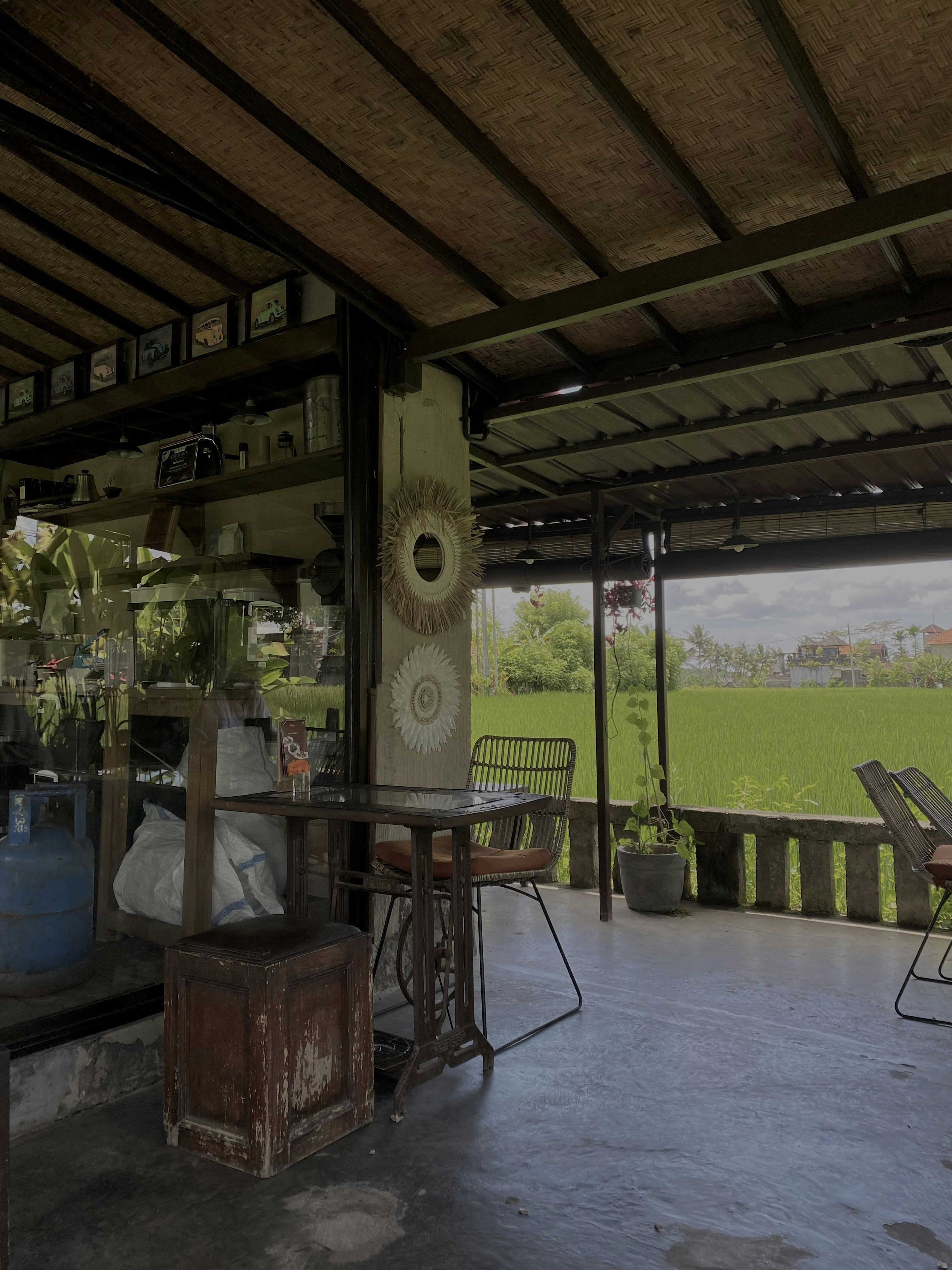 a covered patio with a table and chairs