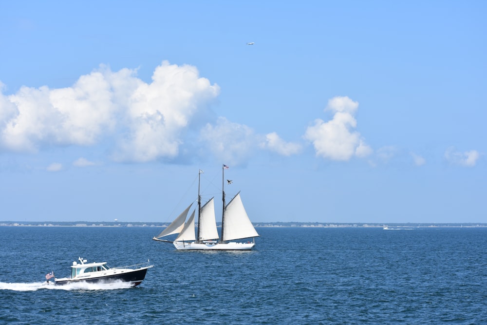 two sailboats in the ocean on a sunny day