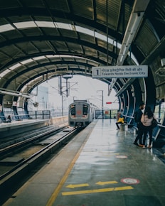 a train pulling into a train station next to a platform