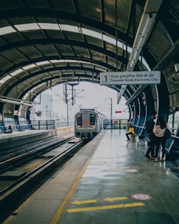 a train pulling into a train station next to a platform