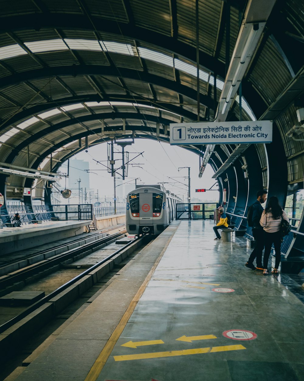 a train pulling into a train station next to a platform