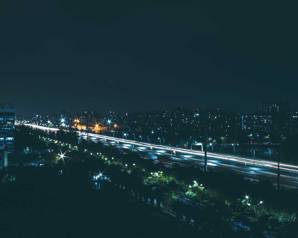 a night time view of a highway and a city