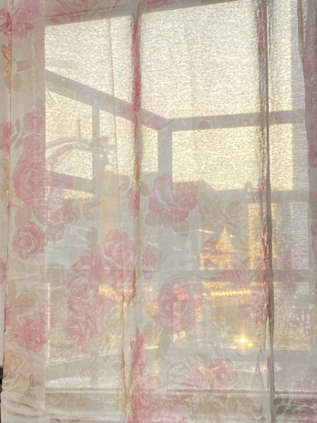 Elegant pink blackout curtains paired with sheer drapes.