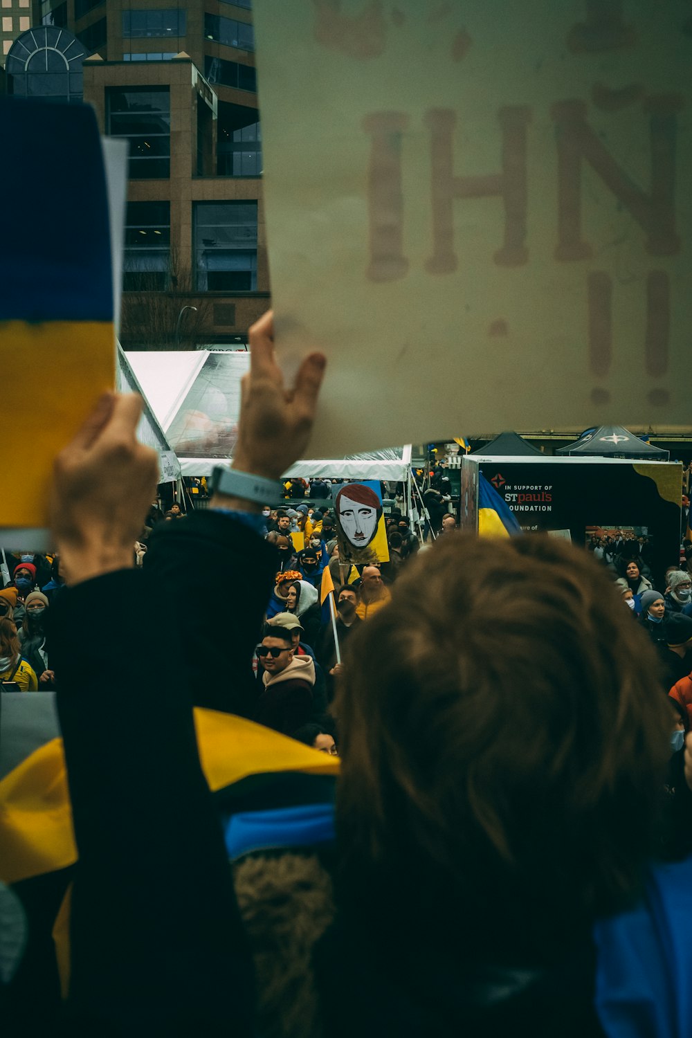 a group of people holding up signs in the air