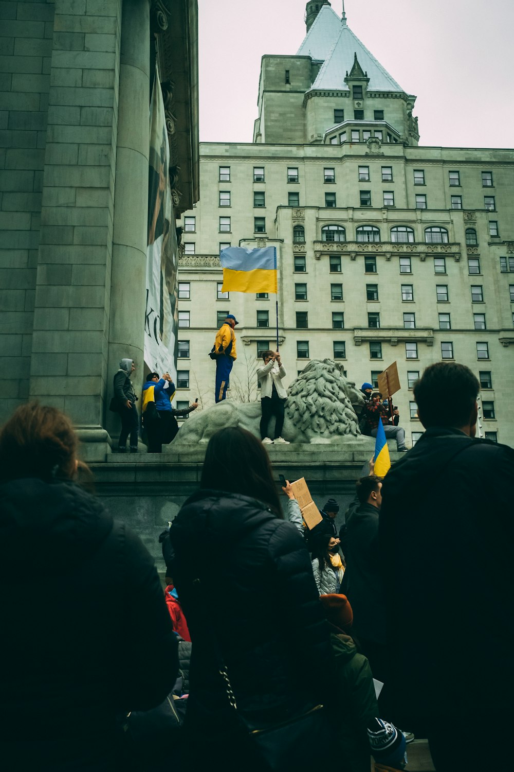 a group of people standing on top of a stone building