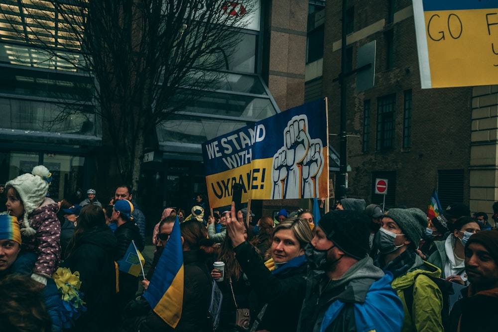 a large group of people holding up signs