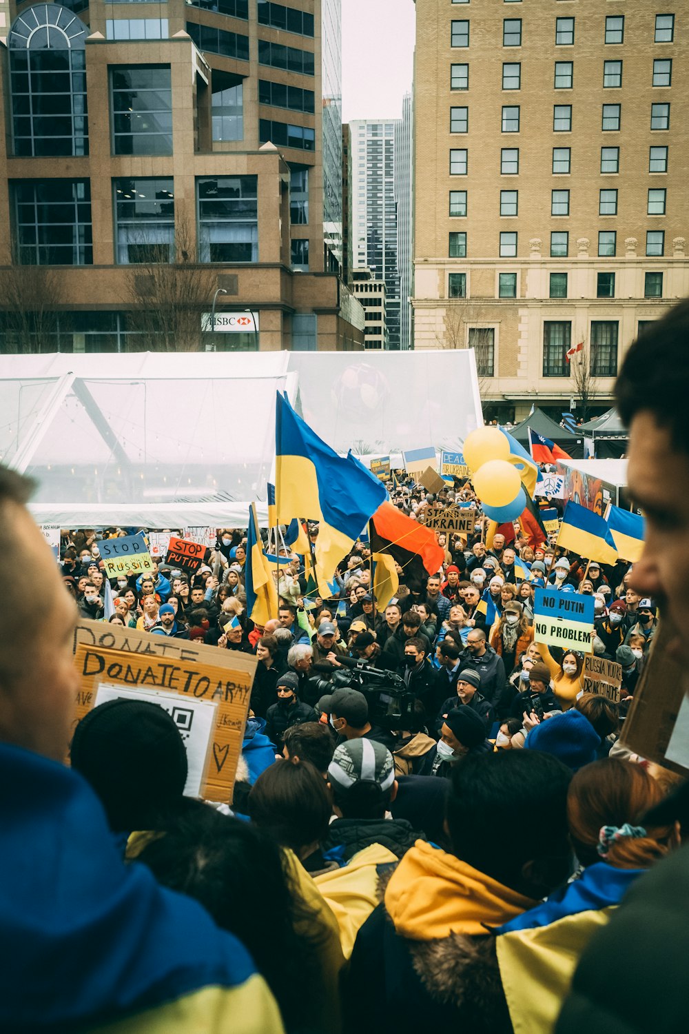 a crowd of people standing around each other