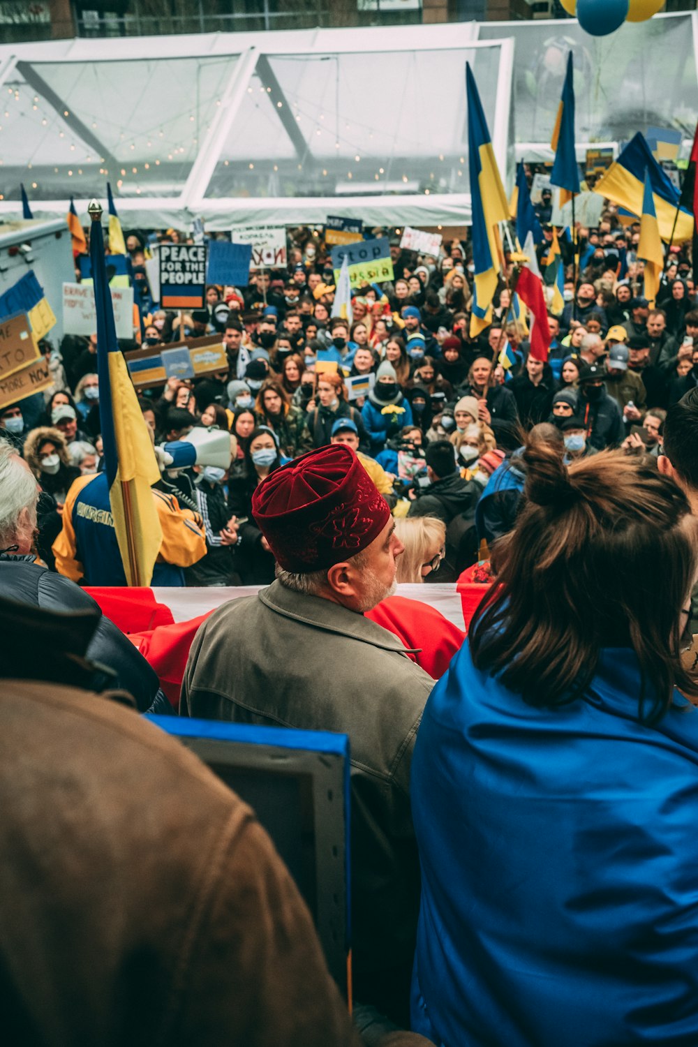 a crowd of people standing around each other