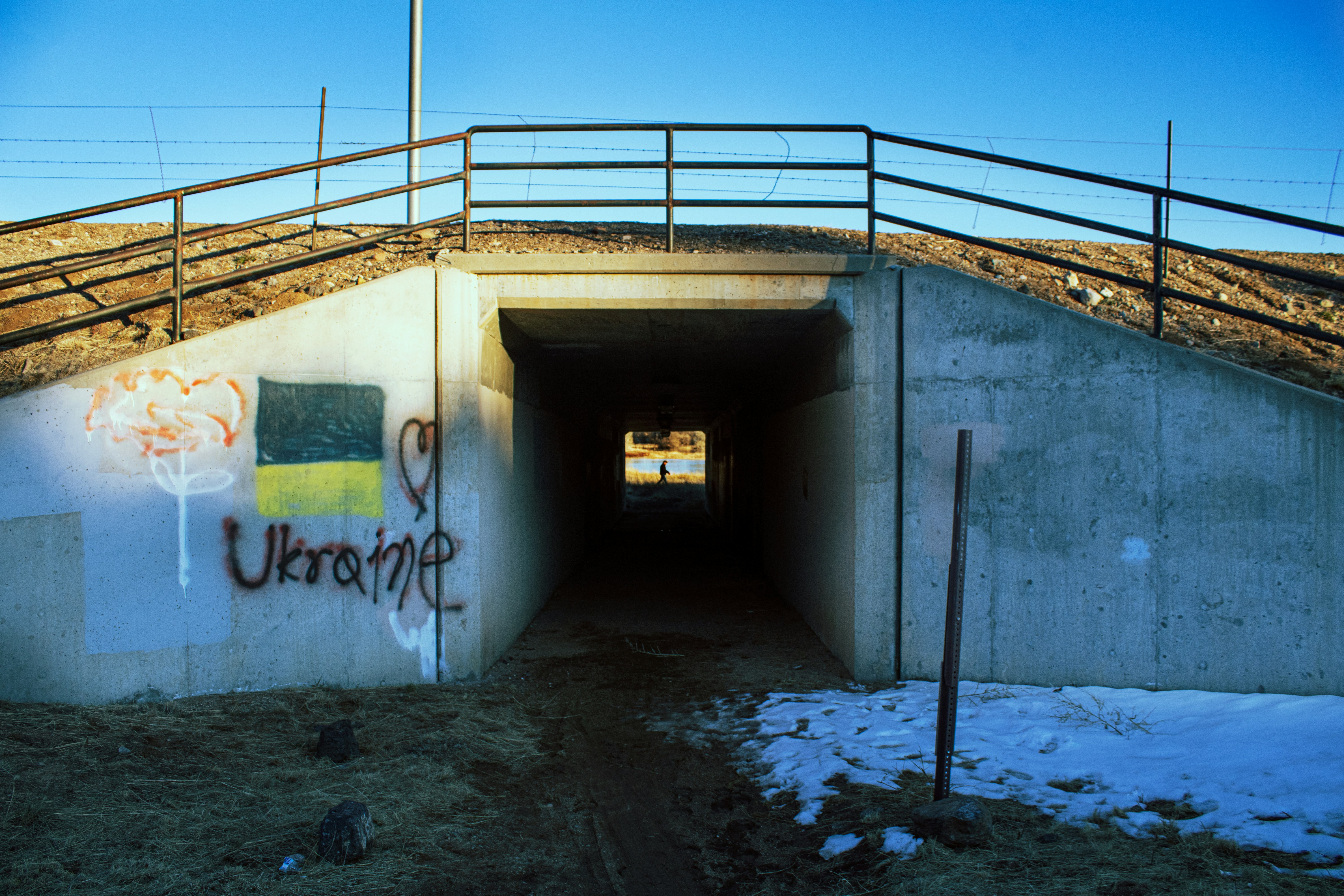 a tunnel with graffiti on the side of it