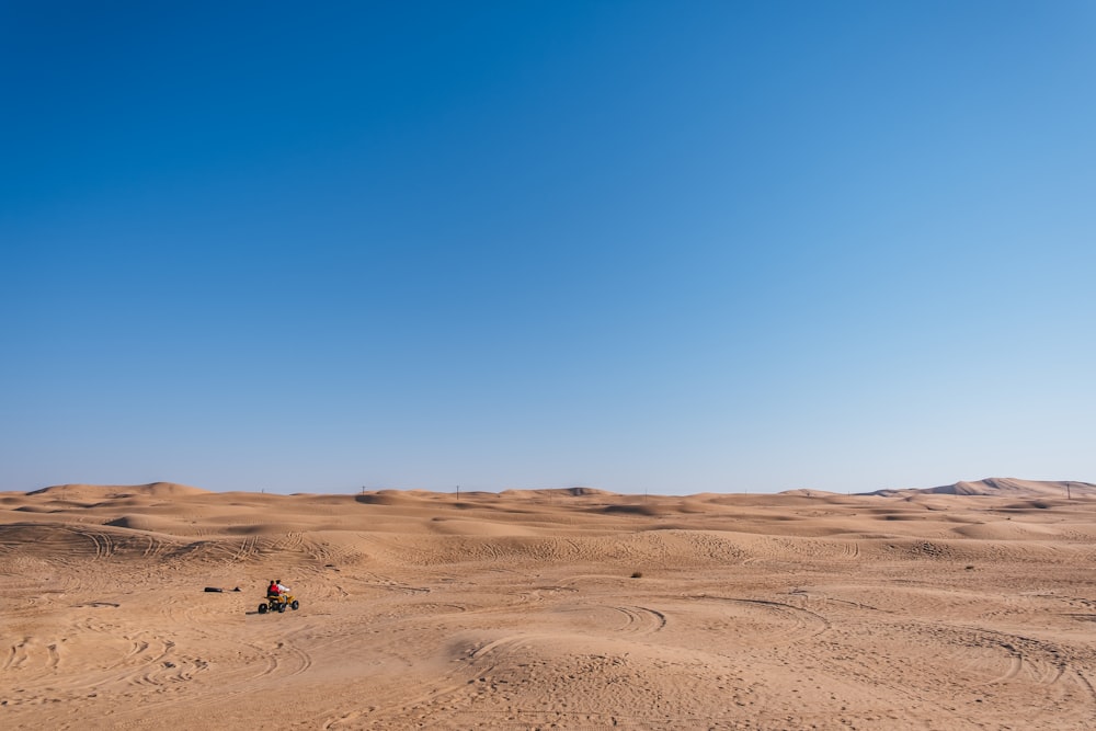 a person riding a motorcycle in the middle of a desert